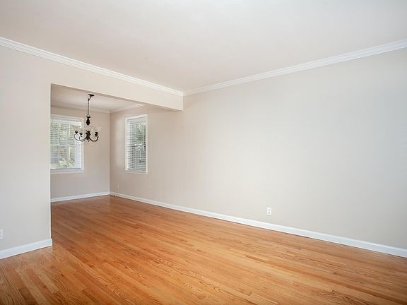 Enter into the living room, with wood floors and fresh neutral paint.