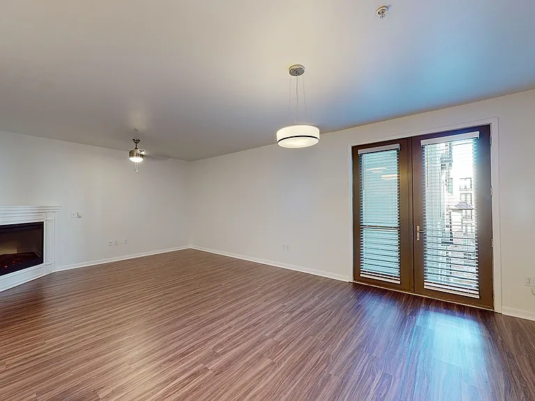 Apartment living room with wood-style flooring.