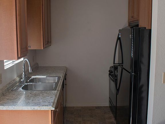 Newly updated kitchen with new cabinets, fridge, oven, and dishwasher.