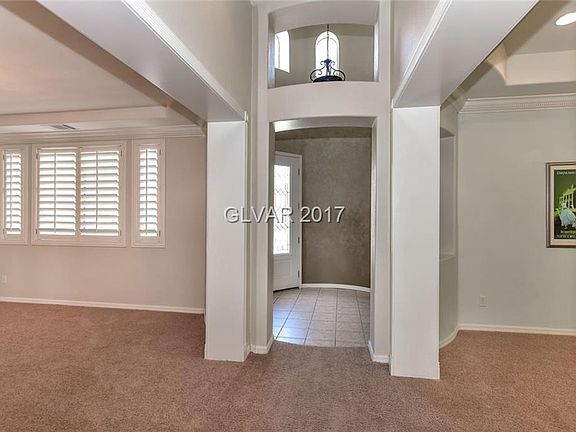 A look at the cathedral ceiling round entry, formal living space to the right and formal dining space to the left