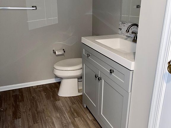Hall bath with new flooring, vanity, and toilet