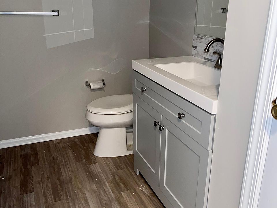 Hall bath with new flooring, vanity, and toilet
