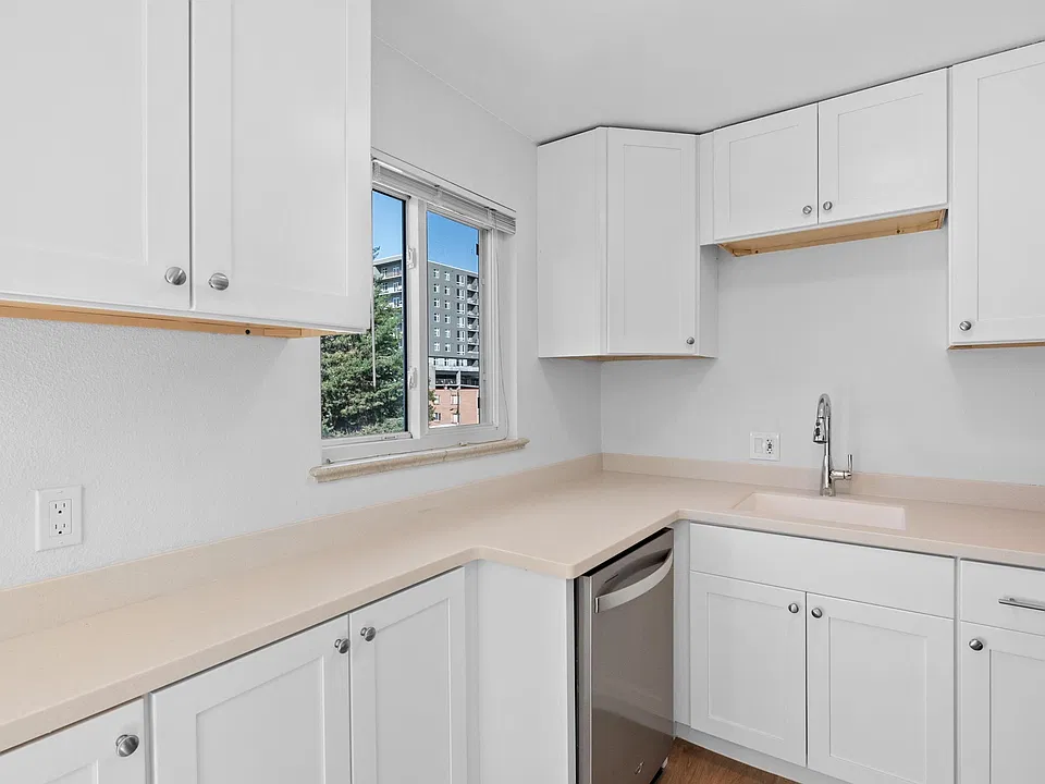 Kitchen with dishwasher and integrated corian countertops