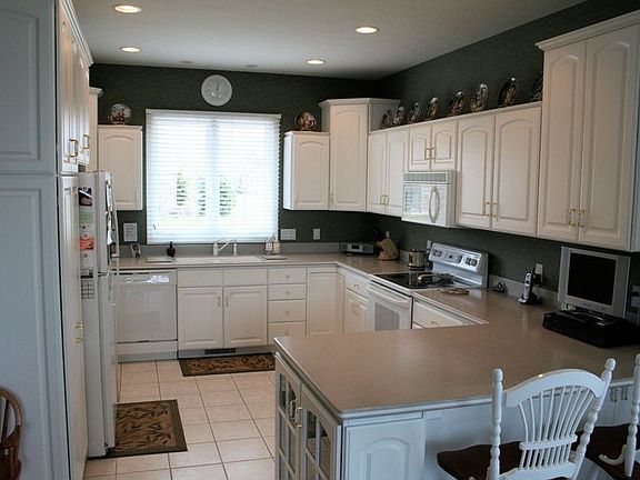Solid surface countertops, ceramic tile flooring