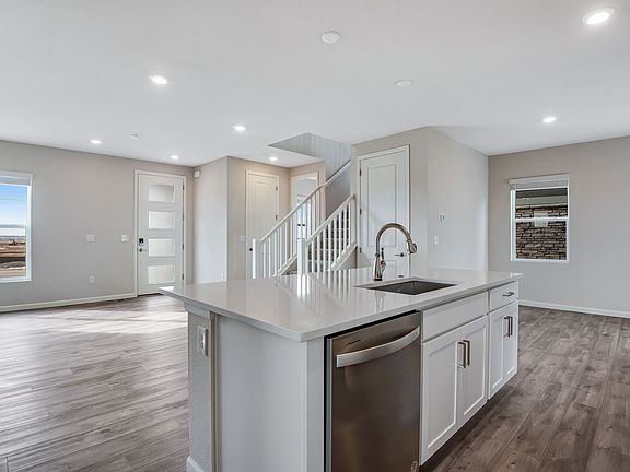Kitchen, great room and front entry with luxury vinyl flooring