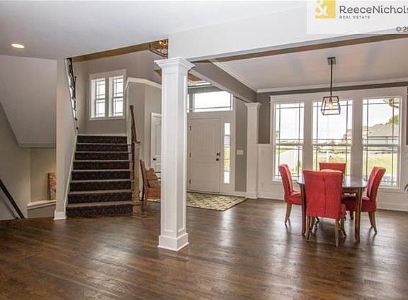 ENTRANCE  - FORMAL DINING AND SWITCHBACK STAIRWAY TO 2ND LEVEL - ALL GORGEOUS WOOD FLOORS