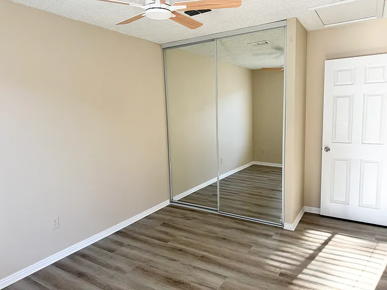 Bedroom #2 with mirror closet and new ceiling fan