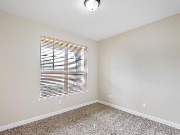 This secondary bedroom with a full bath just steps away is located on the first floor. The room is spacious and offers a nice sized closet. The room is filled with soft, natural light that streams from the double windows.