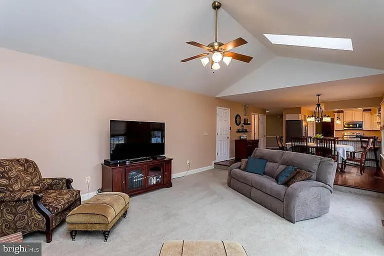 Family Room with view into the kitchen, laundry room/garage entrance + guest restroom/half bath