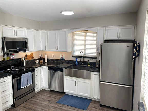 Renovated kitchen with stainless steel appliances and granite countertops. Separate tap with filtered drinking water.