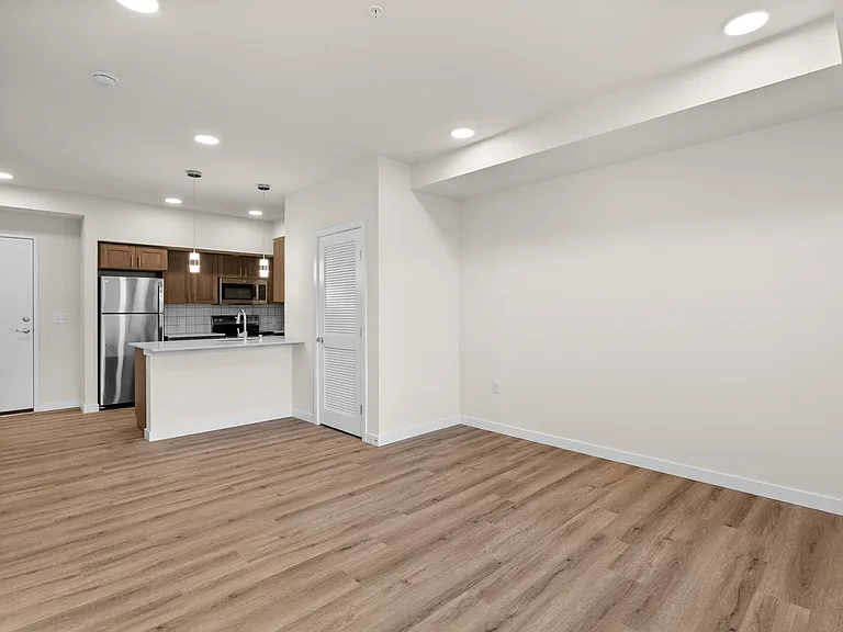 Spacious open-concept living area with seamless flow into the modern kitchen. Spacious open-concept living area with seamless flow into the modern kitchen.