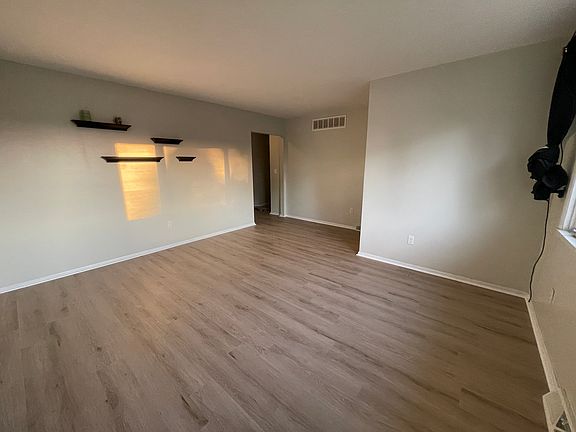 Living room with abundant natural light from west-facing windows.