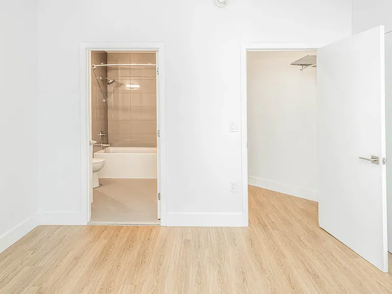Bedroom with Hardwood Flooring and Walk-in Closet