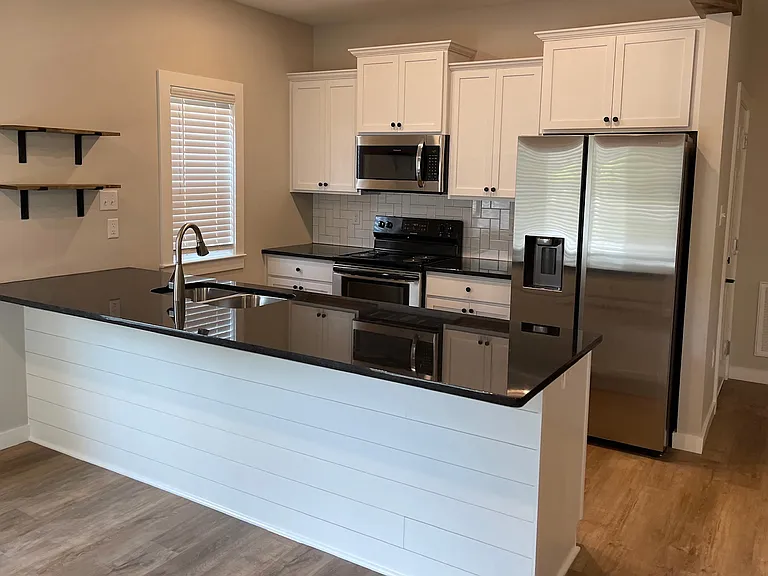 Kitchen with stainless Refrigerator, Microwave, Stove & Dishwasher.