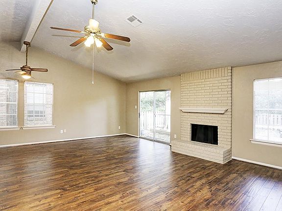 FAMILY ROOM WITH BRICK FIREPLACE ~ NOTE THE NATURAL LIGHTING ~