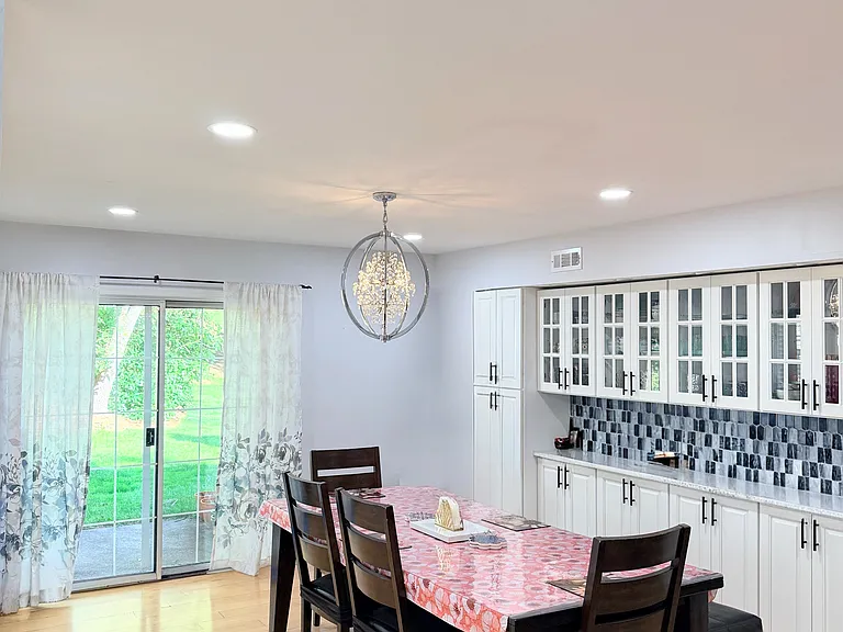 Dining area with ample built-in storage. Opens up to an uncovered patio with a patio shed.