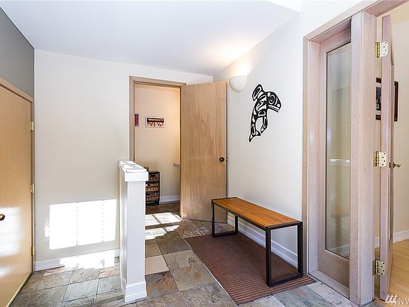 Bright entry with garage entrance (left) half bath (middle door) and easy entry into the home (right).