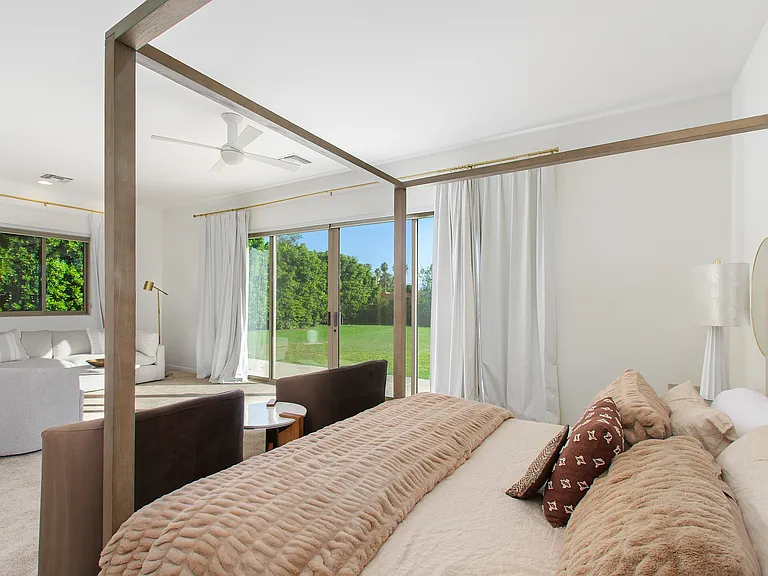 PRIMARY BEDROOM SUITE HAS 2 WALK IN CLOSETS AND DIRECT ACCESS TO POOL, SPA, AND BACK YARD