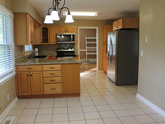 SUNNY EAT IN KITCHEN, LOTS OF CABINETS FOR STORAGE. SS APPLIANCE. 24.5 X 10 WITH STUDENT DESK AND GLASS CABINETS