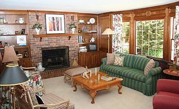 THE FAM RM W/ JUDGES PANELING, BRICK FP, BAY WINDOW AND A DOORTO THE POOL DECK