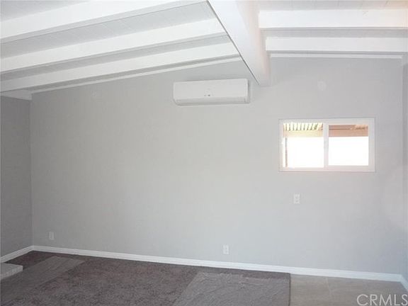 This is a picture of the living room with vaulted ceiling. Notice the box new the ceiling on the wal