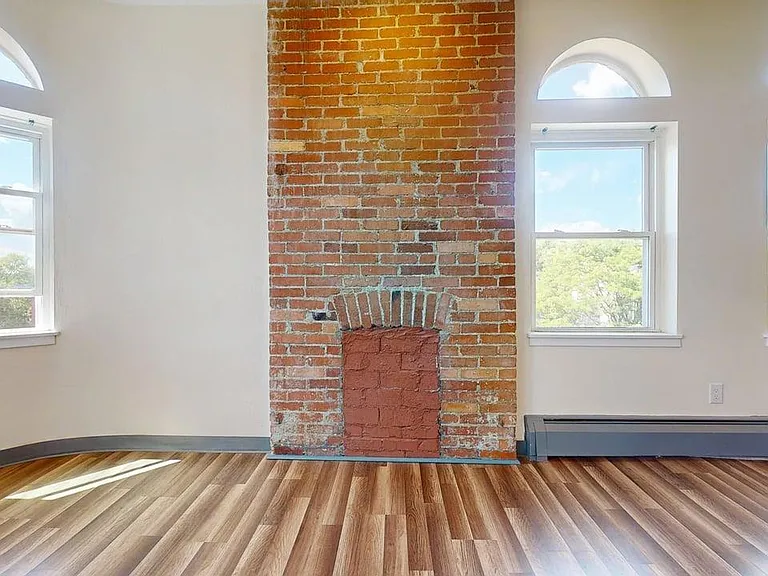 Giant living room with panoramic view of city and decorative fireplace