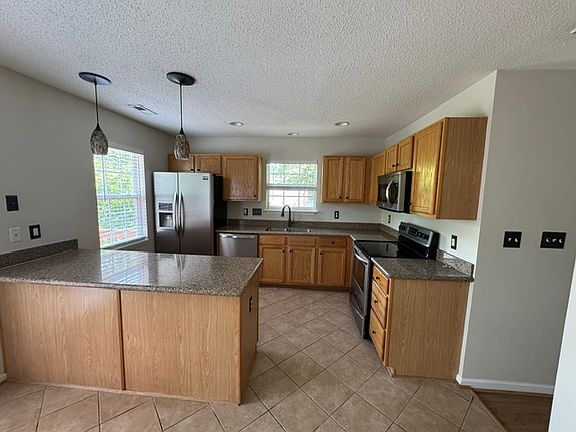 Updated kitchen has granite counters and stainless appliances