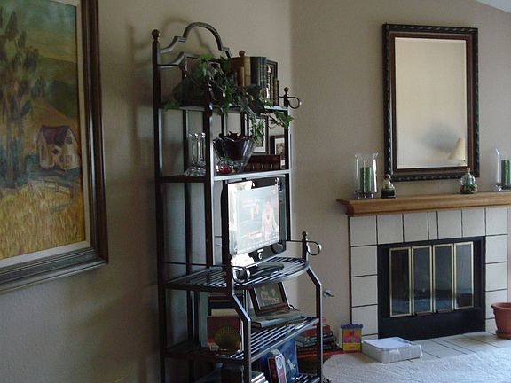 Living room with vaulted ceilings, fireplace and forced air heating