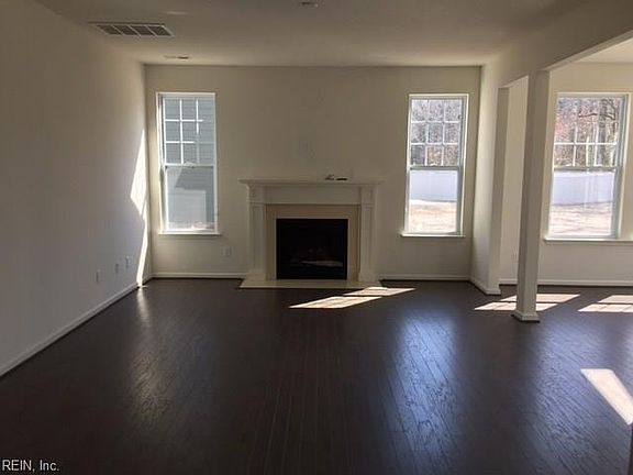 Similar photo of Family room with the sunroom to right.