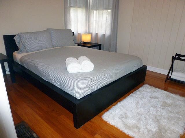 (Unfurnished) Bedroom with ceiling fan and wood floors