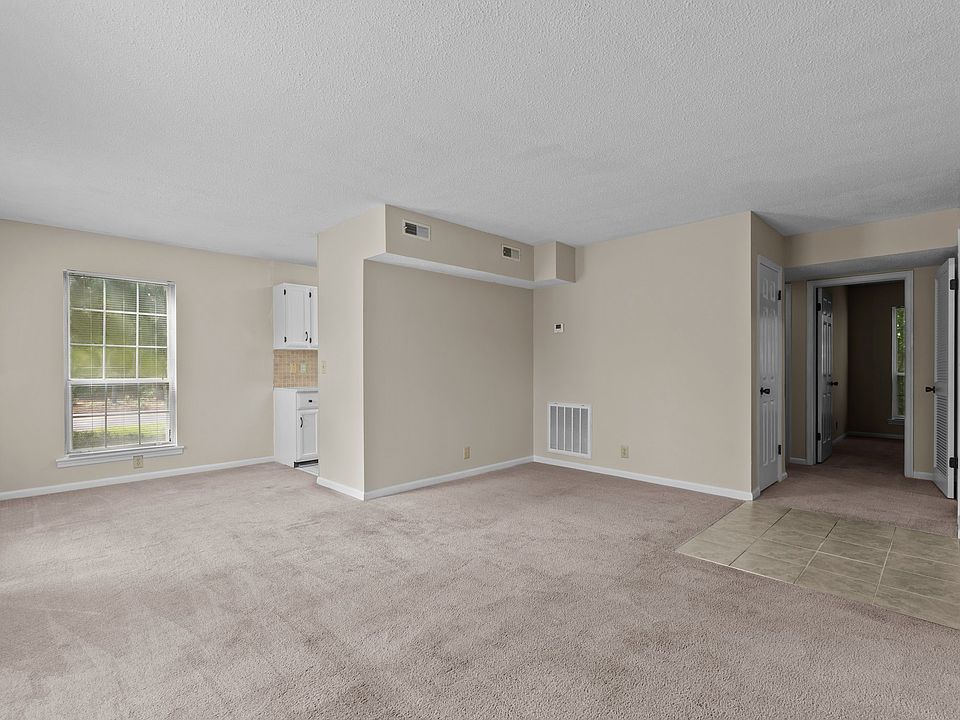 Another view of open living area. Hallway to the right to 2 bedrooms, bathroom, and laundry room. Tiled area is the front door. Kitchen is tucked around the corner on the left side of the photo. No carpet but snap plank flooring.