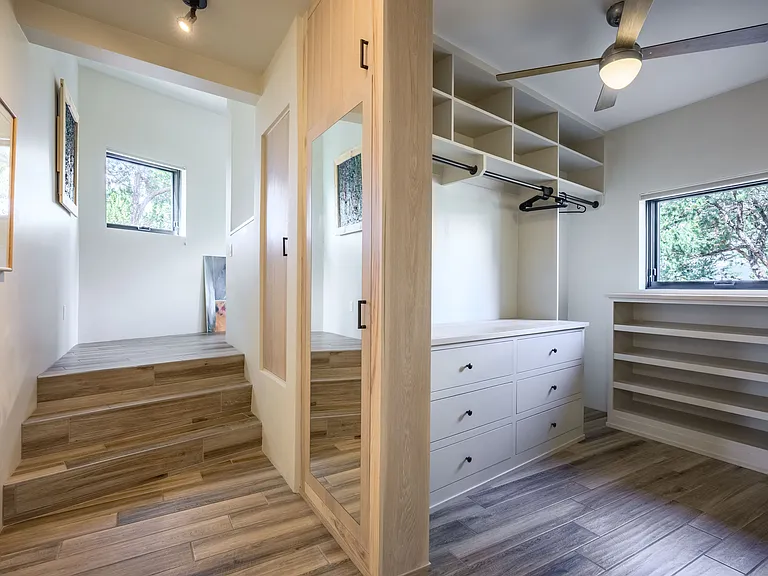 Master walk-in closet and steps up to the private office