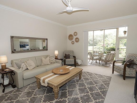 Spacious living area w/queen sleeper sofa, large TV, and small built-in bar ... This area can be expanded into the enclosed back lanai by opening the sliding stacker doors.