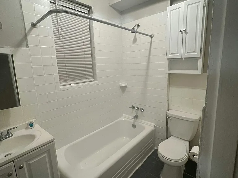 Updated bathroom with freshly painted vanity and functional storage