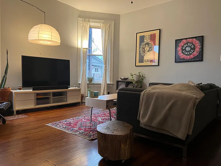 Living room with 12 foot ceilings and refinishing original hardwood floors