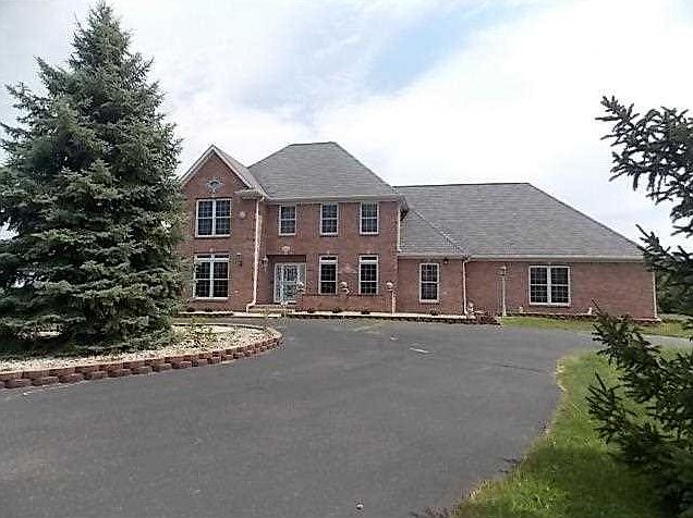 Exterior Front. Beautiful executive brick home with awesome views from many rooms setting on a lovely hilltop 6.5 acre setting.  Custom trim package. There are 16 spacious rooms in this home and that does not include the 4 bathrooms. Circular asphalt driv