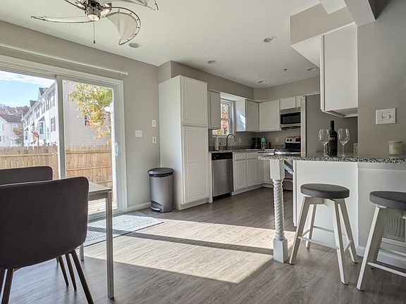 Eat-in kitchen with table for 4 and additional bar seating for 2.