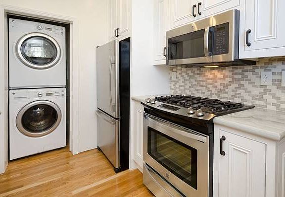 Unit #402 kitchen with (gas) stove and in-unit washer and dryer!