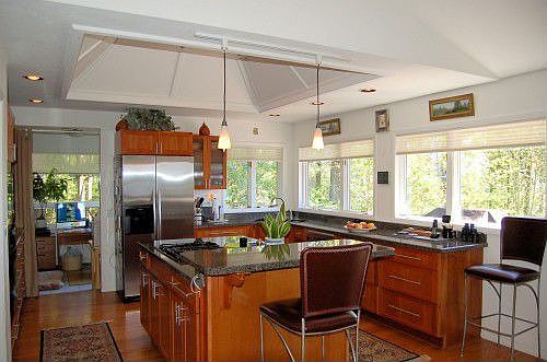 Gorgeous kitchen has cherry cabinetry and granite counters.