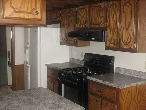 Cooking side of kitchen...notice newer stove and counter tops
