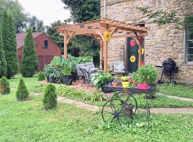 Several Beautiful Back Areas-
The Elephant patio (shown) is under construction, There is the "Grape Cove" with 4seating and elegant white lighting, Secret Garden with 
8 seating, outdoor electric, Protection from sun & rain & The English Garden