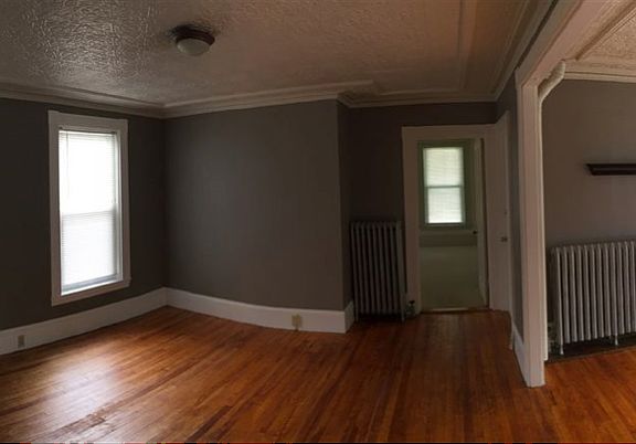 Dining room has beautiful morning light, a well-preserved 8+ foot tin ceiling and lovely hardwood floors.