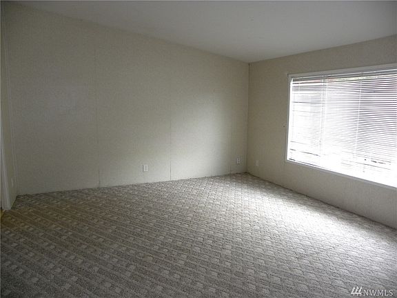 Picture shows the family room looking to the dining room into the kitchen.
