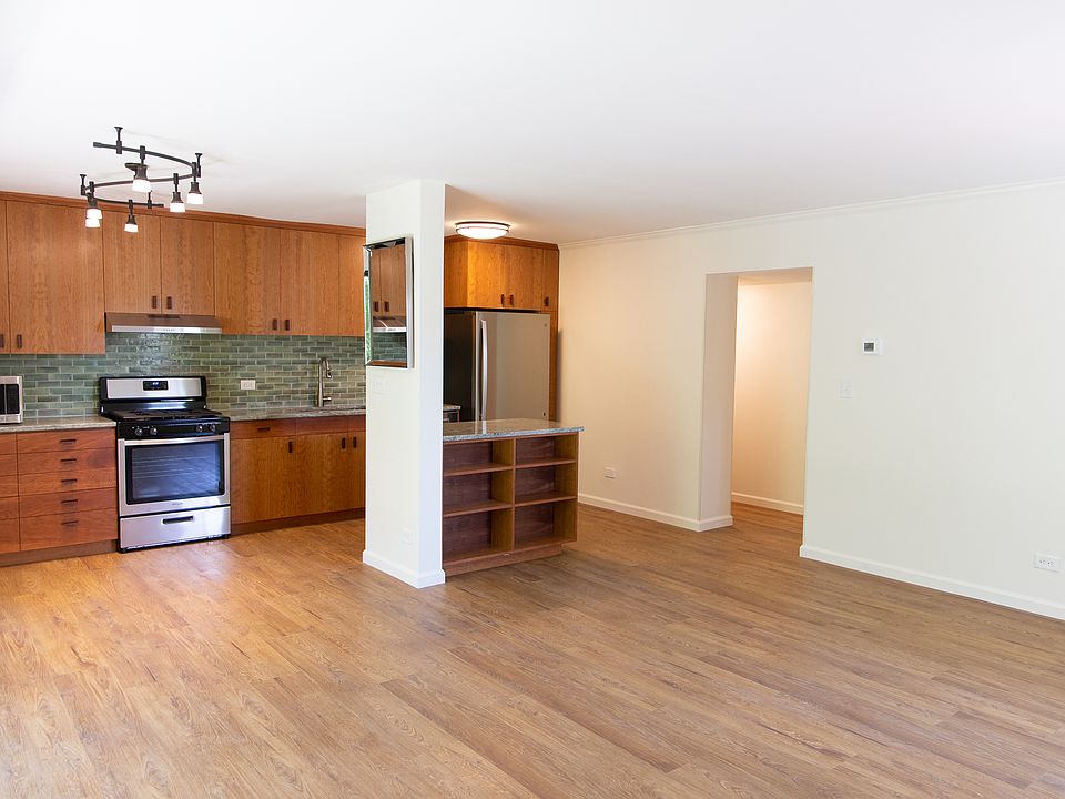 Door to entry hall, book shelves on the kitchen peninsula