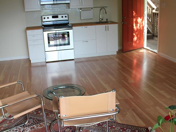 Living room, kitchen area, open door to stairs