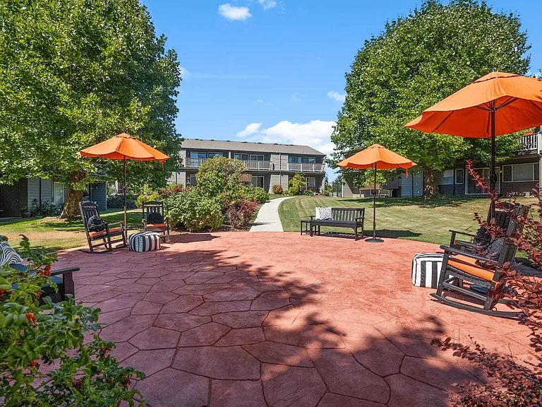Relax in style on our vibrant patio with shaded seating and cozy spaces.