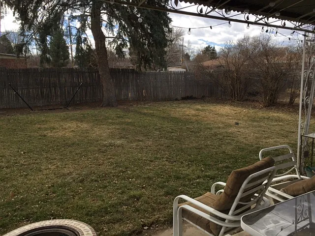Fenced backyard with mature trees