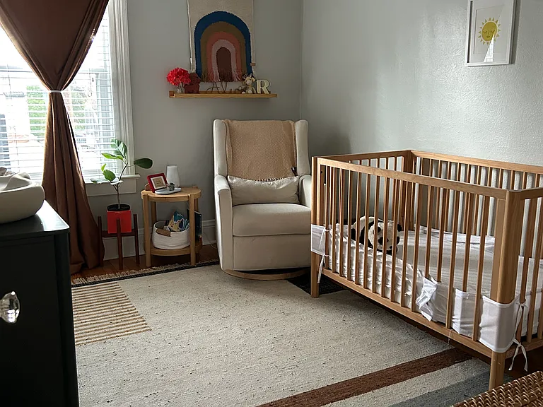 Bedroom 2 (shown as nursery but can comfortably fit a queen bed, dresser, nightstands, shelves)