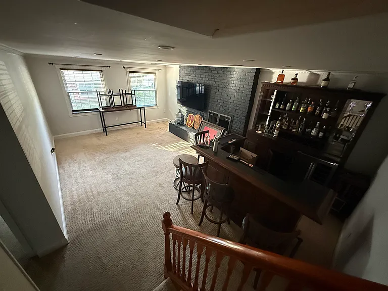 From middle level looking at the bottom level - den/living room space. (Bar is not included)