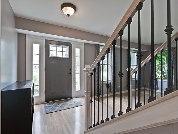 Step inside to a bright open foyer highlighting the custom railings.